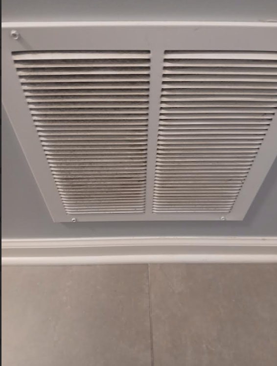 Air vent before cleaning - bright white and spotless with clean slats